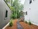 Exterior view of a modern house with gray siding, set amidst a wooded landscape, showcasing the connection to nature at 135 Cedarwood Ln, Roswell, GA 30075