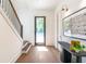 Sunlit foyer features hardwood floors, modern decor, a staircase, and a welcoming entrance at 135 Cedarwood Ln, Roswell, GA 30075
