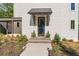 Inviting front entrance with a covered porch and manicured landscaping at 135 Cedarwood Ln, Roswell, GA 30075