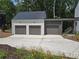 Spacious three-car garage with concrete driveway at 135 Cedarwood Ln, Roswell, GA 30075
