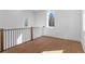 Hallway featuring wood floors, modern railing, and multiple windows at 135 Cedarwood Ln, Roswell, GA 30075