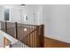 Upstairs hallway with hardwood floors, modern railings, and natural light at 135 Cedarwood Ln, Roswell, GA 30075