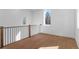 Second story hallway features hardwood floors, wrought iron railings, and a scenic window at 135 Cedarwood Ln, Roswell, GA 30075