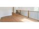 Hallway with beautiful hardwood floors, detailed railing, and natural light at 135 Cedarwood Ln, Roswell, GA 30075