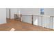 Bright upstairs hallway with hardwood floors, wrought iron railings, and scenic views at 135 Cedarwood Ln, Roswell, GA 30075