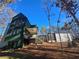 Modern home with a dark green exterior and detached garage at 135 Cedarwood Ln, Roswell, GA 30075