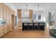 Open-concept kitchen with a black island, pendant lighting, and modern appliances at 135 Cedarwood Ln, Roswell, GA 30075