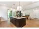 Open kitchen with large island, modern lighting, and stainless appliances perfect for cooking and gathering at 135 Cedarwood Ln, Roswell, GA 30075