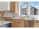 Well-lit kitchen with stainless steel appliances, light wood cabinets, and a view from the window at 135 Cedarwood Ln, Roswell, GA 30075