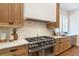 Chef's kitchen featuring stainless steel appliances, granite countertops and custom cabinetry at 135 Cedarwood Ln, Roswell, GA 30075