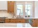 Well-lit kitchen featuring wooden cabinetry, modern appliances, and ample counter space for food prep at 135 Cedarwood Ln, Roswell, GA 30075