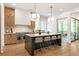 Contemporary kitchen boasts a large island, stainless appliances, and access to an outdoor patio at 135 Cedarwood Ln, Roswell, GA 30075