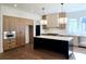 Modern kitchen with island, hardwood floors, and stainless steel appliances at 135 Cedarwood Ln, Roswell, GA 30075