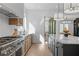 Bright kitchen with stainless steel appliances, hardwood floors, and a center island at 135 Cedarwood Ln, Roswell, GA 30075