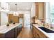 Well-lit kitchen featuring a central island, stainless steel appliances, and modern fixtures at 135 Cedarwood Ln, Roswell, GA 30075