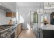 Modern kitchen with stainless steel appliances, stone counters, ample cabinet space, and bright natural light at 135 Cedarwood Ln, Roswell, GA 30075