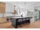 Open-concept kitchen with modern appliances, island seating, and access to an outdoor deck at 135 Cedarwood Ln, Roswell, GA 30075