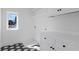 Well-lit laundry room with geometric tile, white cabinets, and view to exterior at 135 Cedarwood Ln, Roswell, GA 30075