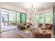 Bright living room with access to a covered porch, neutral colors, and ample seating at 135 Cedarwood Ln, Roswell, GA 30075