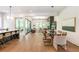 Open-concept living area featuring hardwood floors, modern decor, dining space, and seamless indoor-outdoor flow at 135 Cedarwood Ln, Roswell, GA 30075