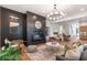 Open concept living room featuring a fireplace and view into the kitchen, breakfast nook, and backyard at 135 Cedarwood Ln, Roswell, GA 30075