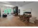 Open-concept living room with fireplace, modern decor, hardwood floors, and lots of natural light at 135 Cedarwood Ln, Roswell, GA 30075
