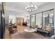 Inviting living room with hardwood floors, stylish seating, and views into the adjacent kitchen at 135 Cedarwood Ln, Roswell, GA 30075