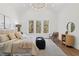 Main bedroom with hardwood floors, three windows, and a modern chandelier at 135 Cedarwood Ln, Roswell, GA 30075