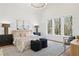 Main bedroom with hardwood floors, three windows, and stylish decor at 135 Cedarwood Ln, Roswell, GA 30075