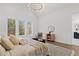 Main bedroom with hardwood floors, three windows, and neutral decor at 135 Cedarwood Ln, Roswell, GA 30075