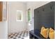 Bright mudroom featuring hexagon tile, a storage bench with hooks, and a view to the home's exterior at 135 Cedarwood Ln, Roswell, GA 30075