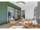 Relaxing covered patio with comfortable seating and sliding glass doors at 135 Cedarwood Ln, Roswell, GA 30075