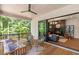 Inviting covered patio with stylish furniture, a ceiling fan, and seamless access to an indoor living area with a fireplace at 135 Cedarwood Ln, Roswell, GA 30075