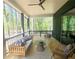 Comfortable outdoor seating on a spacious screened in patio with wooded views at 135 Cedarwood Ln, Roswell, GA 30075