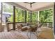 Inviting covered porch with comfortable seating and a ceiling fan, perfect for relaxation at 135 Cedarwood Ln, Roswell, GA 30075