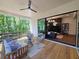 Stylish covered porch with seating area flows seamlessly into the living room through a large sliding glass door, connecting indoor/outdoor spaces at 135 Cedarwood Ln, Roswell, GA 30075