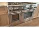 Close-up of stainless steel range with double oven in kitchen, adding style and functionality at 135 Cedarwood Ln, Roswell, GA 30075