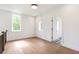 Bright, airy room with hardwood floors, large windows offering ample natural light, and neutral-toned walls at 135 Cedarwood Ln, Roswell, GA 30075