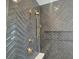 Spa-like shower with herringbone tile and gold fixtures at 135 Cedarwood Ln, Roswell, GA 30075