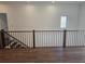 Upstairs hall with hardwood floors and modern railing at 135 Cedarwood Ln, Roswell, GA 30075