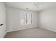 Bedroom with window, plush carpeting, ceiling fan, and neutral wall color at 1515 Bullard Pl, Powder Springs, GA 30127