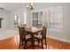 Hardwood dining area filled with natural light and access to living room at 1515 Bullard Pl, Powder Springs, GA 30127