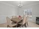 Formal dining room with a wooden table and large bright window with plantation shutters at 1515 Bullard Pl, Powder Springs, GA 30127