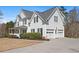 Exterior view of a two-story home with a three car garage and well-maintained landscaping at 1515 Bullard Pl, Powder Springs, GA 30127