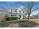 Charming two-story home with a welcoming front porch, complemented by lush landscaping and mature trees at 1515 Bullard Pl, Powder Springs, GA 30127