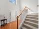 Bright foyer featuring hardwood floors and a staircase leading to the upper level at 1515 Bullard Pl, Powder Springs, GA 30127