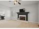 Bright living room with fireplace, ceiling fan, and neutral carpet at 1515 Bullard Pl, Powder Springs, GA 30127