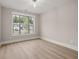 Bright bedroom featuring wood-look floors and a window at 320 Sobeck Way, Canton, GA 30115