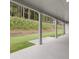 Covered patio with concrete flooring overlooks a grassy backyard at 320 Sobeck Way, Canton, GA 30115