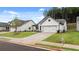 White craftsman style house with a two-car garage and a landscaped lawn at 320 Sobeck Way, Canton, GA 30115